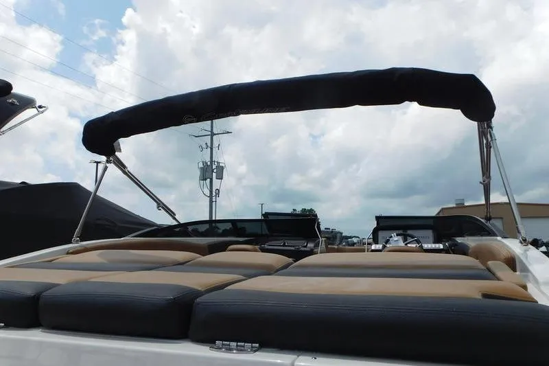 Slide: The Image of 2024 Crownline 220 SS LPX boat displayed in a showroom, featuring sleek design and modern amenities. - 2