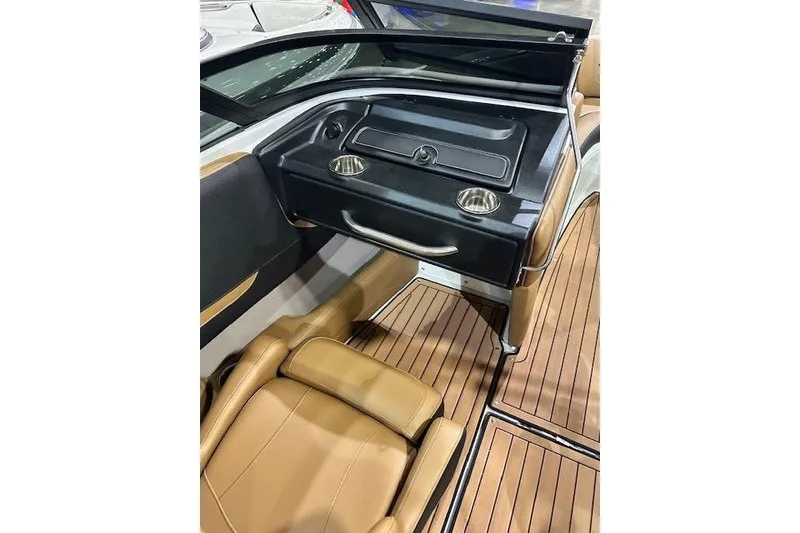 Slide: The Image of 2024 Crownline 220 SS LPX boat interior with tan seating and wood flooring. - 20