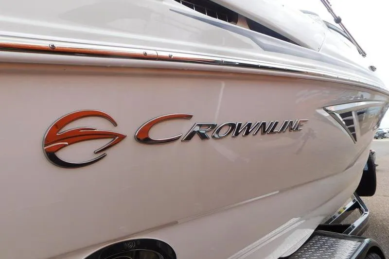 Slide: The Image of 2024 Crownline 220 SS LPX boat interior with tan seating and wood accents. - 6