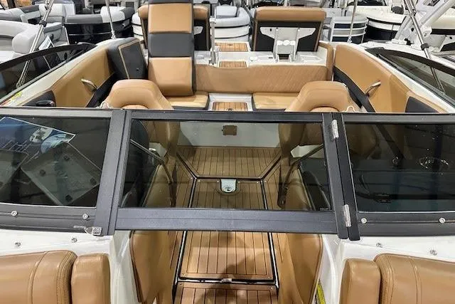Slide: The Image of 2024 Crownline 220 SS LPX boat interior with tan leather seating and sleek design. - 7