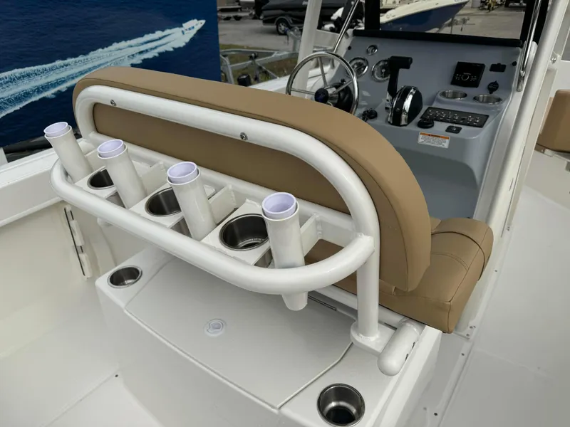 Slide: The Image of 2024 Bayliner Trophy CC22 boat interior with rod holders and helm station. - 3