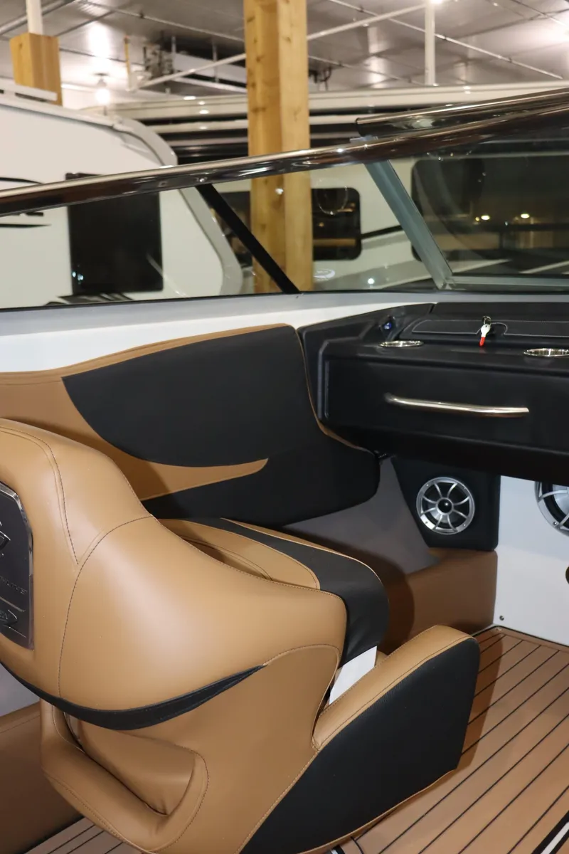 Slide: The Image of 2024 Crownline 240 SS SURF boat interior with tan and black seating. - 11