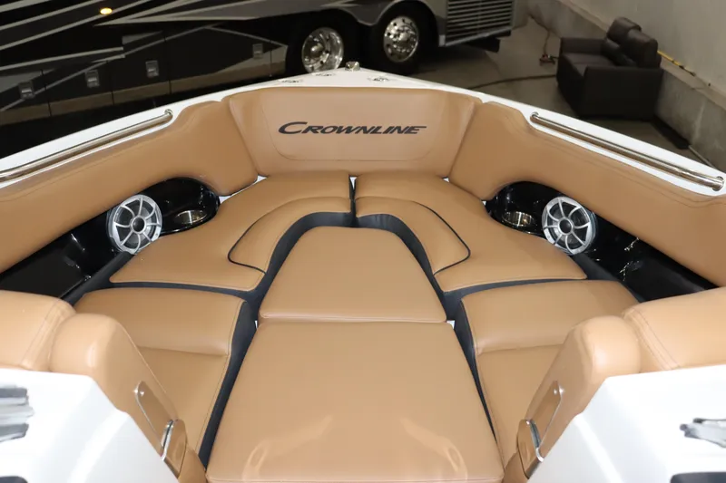 Slide: The Image of 2024 Crownline 240 SS SURF boat interior with tan leather seating and built-in speakers. - 12