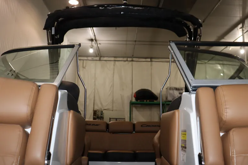 Slide: The Image of 2024 Crownline 240 SS SURF boat interior with tan leather seats and open windshield. - 14