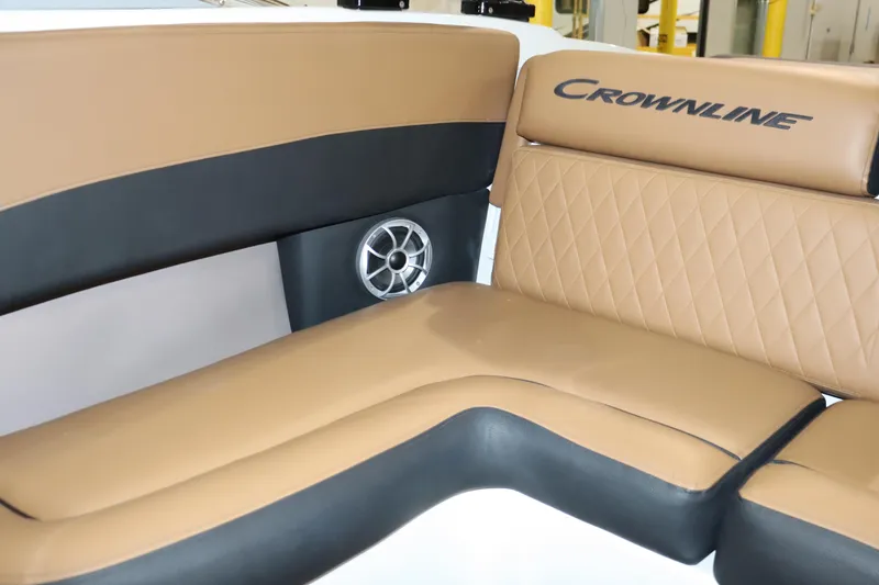 Slide: The Image of 2024 Crownline 240 SS SURF boat interior with tan and black seating. - 18