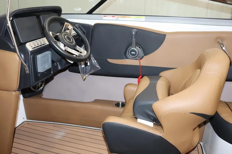 Slide: The Image of 2024 Crownline 240 SS SURF boat interior with steering wheel and captain's seat. - 19