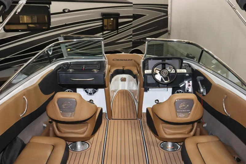 Slide: The Image of 2024 Crownline 240 SS SURF boat interior with tan leather seats and modern dashboard. - 22