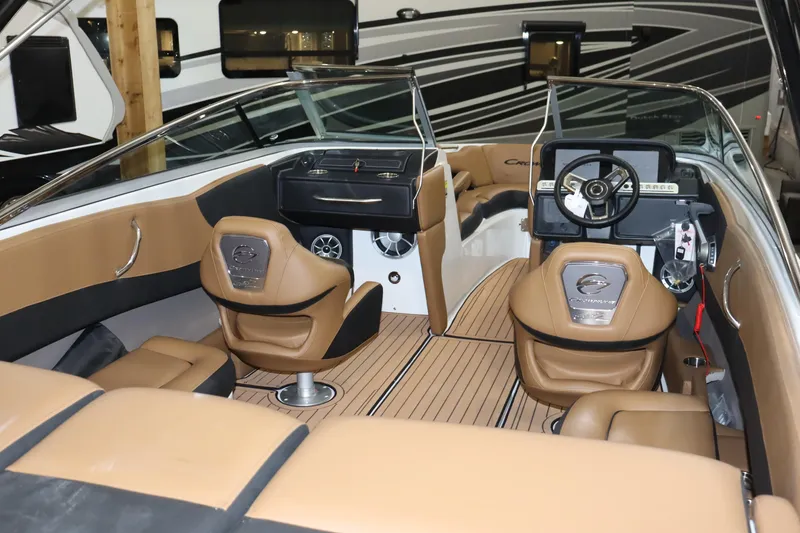 Slide: The Image of Interior of a 2024 Crownline 240 SS SURF boat with tan and black seating. - 23