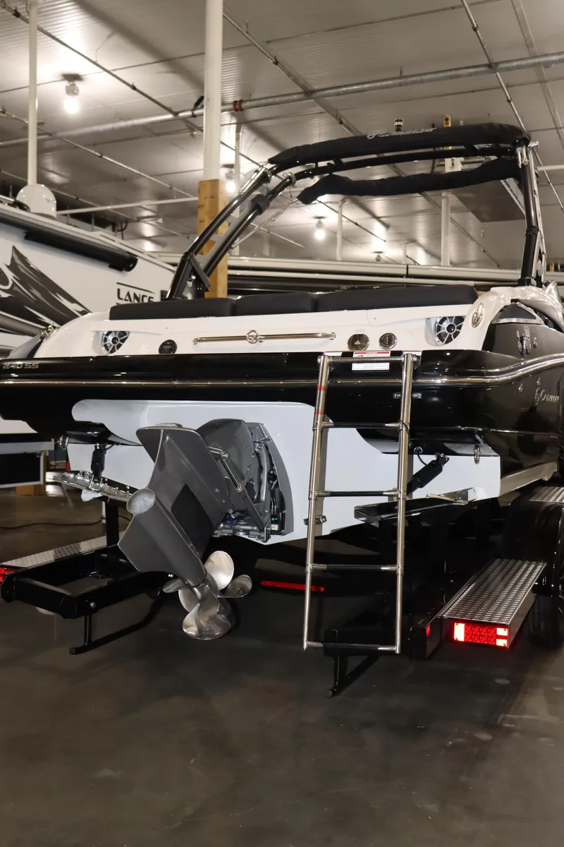 Slide: The Image of 2024 Crownline 240 SS SURF boat in showroom, rear view. - 24