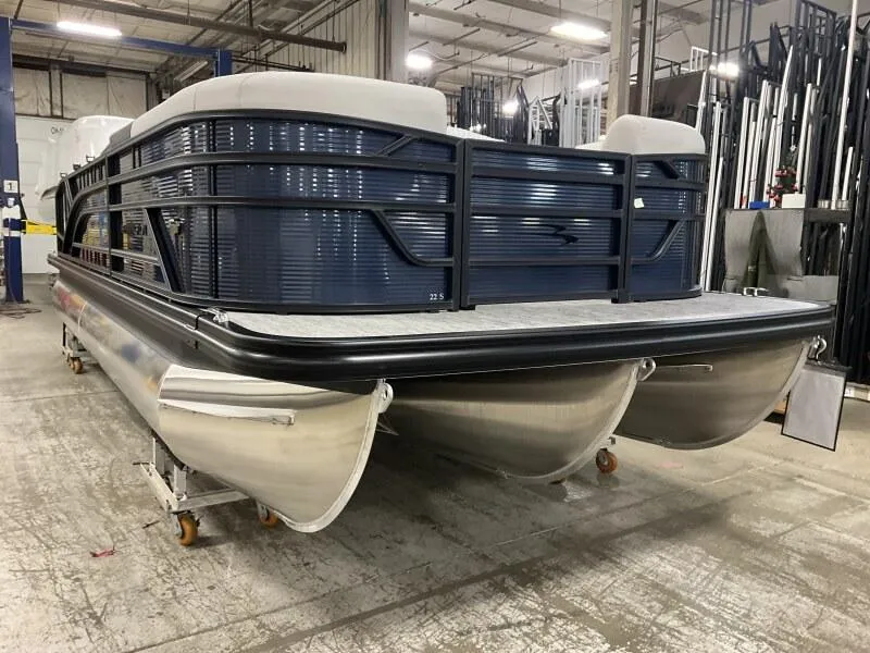 Slide: The Image of 2025 Bennington 22 SSB Swing Back Tritoon with Yamaha F-150Hp in stock, warehouse setting. - 11