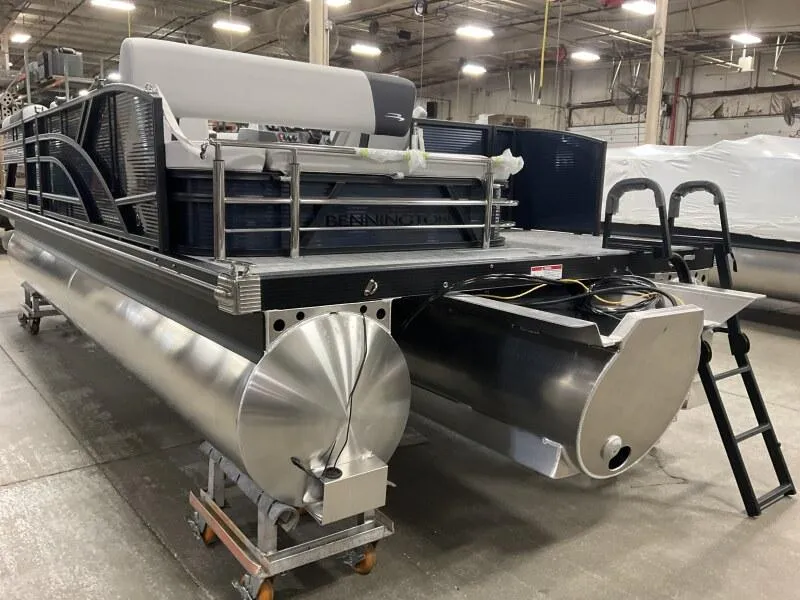 Slide: The Image of 2025 Bennington 22 SSB Tritoon with Yamaha F-150Hp in stock, displayed in a warehouse. - 22