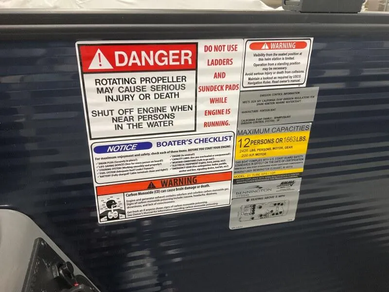 Slide: The Image of Warning labels on a 2025 Bennington 22 SSB Tritoon boat, highlighting safety precautions and capacity limits. - 26
