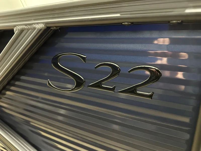 Slide: The Image of Close-up of Bennington 22 SSB Tritoon emblem, 2025 model, featuring sleek metallic design. - 32