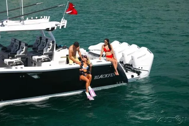 Slide: The Image of 2024 Blackfin 400CC boat with people enjoying water activities. - 19
