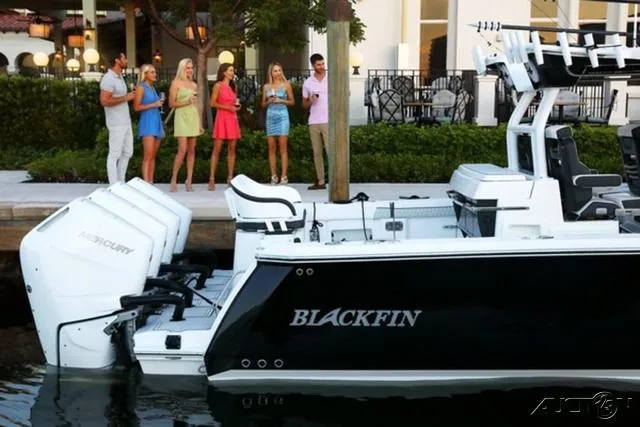 Slide: The Image of 2024 Blackfin 400CC boat docked with people socializing nearby. - 20