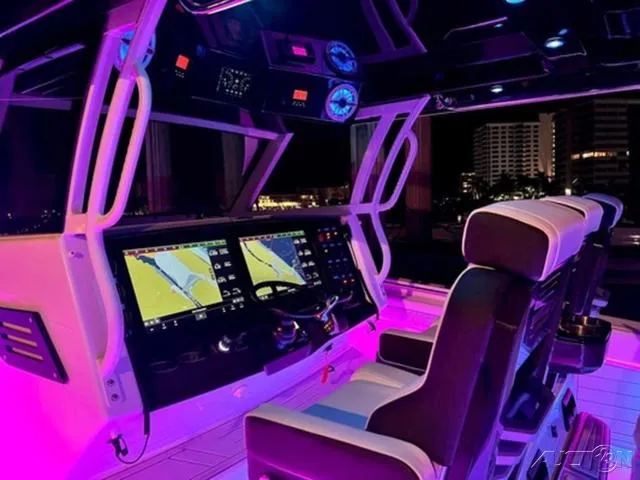 Slide: The Image of 2024 Blackfin 400CC boat cockpit with illuminated navigation screens and seating. - 3