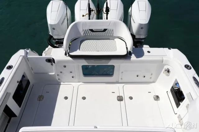 Slide: The Image of 2024 Blackfin 400CC boat deck with triple outboard engines. - 8
