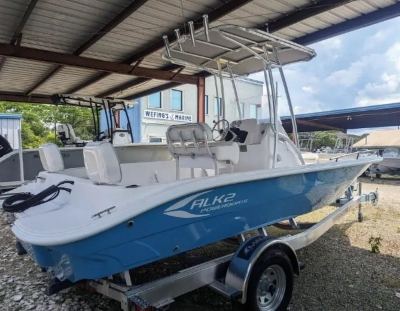 Slide: The Image of 2024 ALK2 Powerboats 22 CRX on trailer under a metal canopy at a marine dealership. - 1