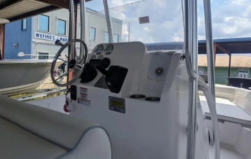 Slide: The Image of 2024 ALK2 Powerboats 22 CRX center console with steering wheel and controls. - 6