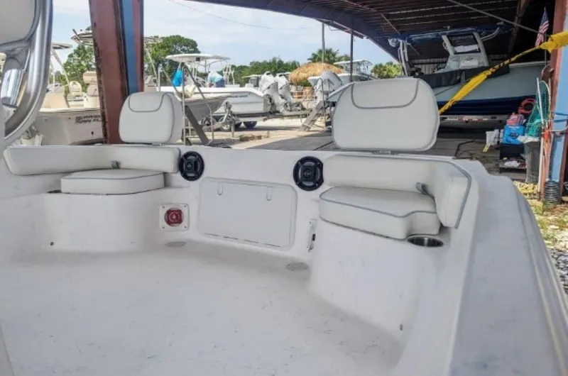 Slide: The Image of 2024 ALK2 Powerboats 22 CRX interior seating area in a boatyard. - 9
