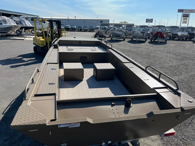 Slide: The Image of 2024 Smoker Craft 1660 Sportsman Pro boat on display at a dealership. - 3