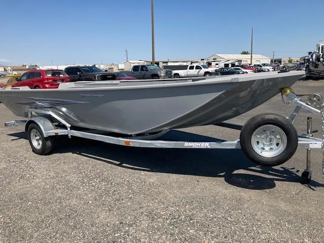 The Image of 2024 Smoker Craft 1866 Pro Sportsman boat on a trailer in a parking lot. - 0