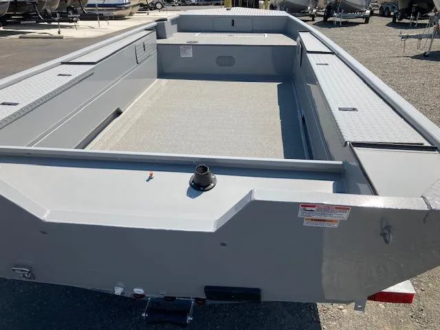 Slide: The Image of 2024 Smoker Craft 1866 Pro Sportsman boat, empty interior view, parked outdoors. - 2