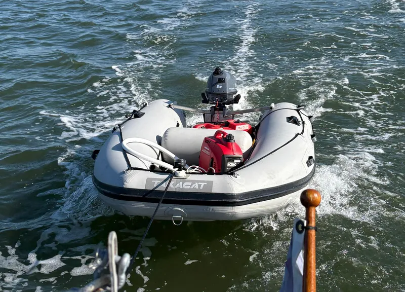 Slide: The Image of Inflatable dinghy with motor on water, viewed from a 1985 Cape Dory 270 boat. - 10