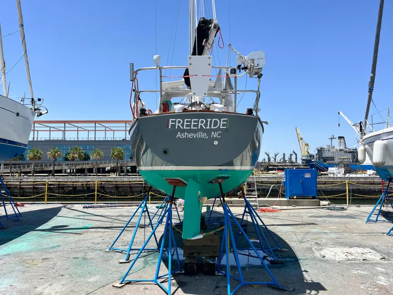 Slide: The Image of 1985 Cape Dory 270 sailboat "Freeride" on stands in a marina. - 13
