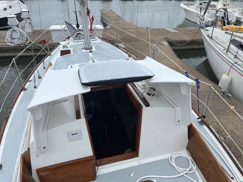 Slide: The Image of 1985 Cape Dory 270 sailboat docked at marina, view of cockpit and cabin entrance. - 17