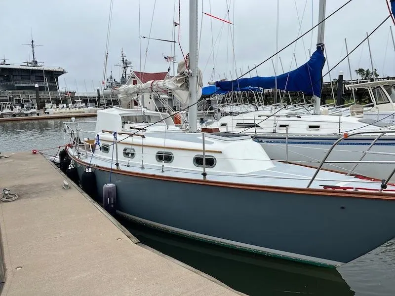 Slide: The Image of 1985 Cape Dory 270 sailboat docked at a marina. - 2