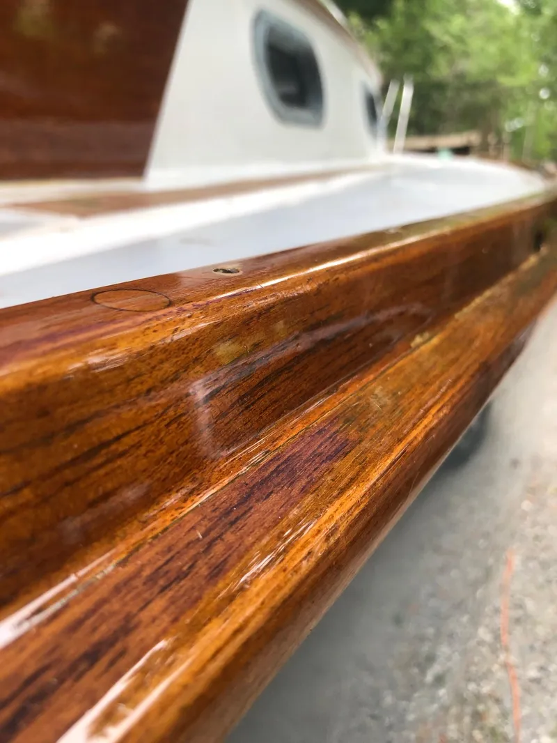 Slide: The Image of Close-up of 1985 Cape Dory 270 boat's polished wooden rail. - 29