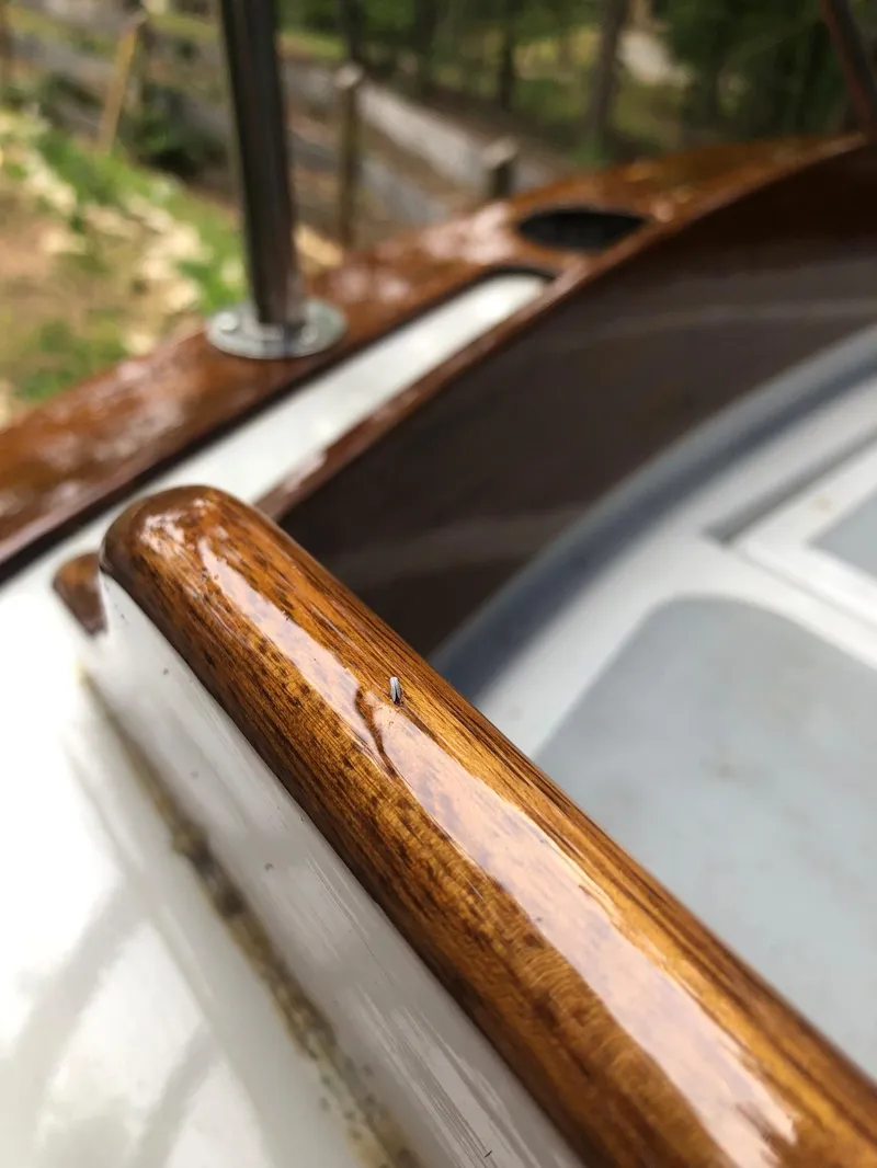 Slide: The Image of Close-up of polished wood railing on a 1985 Cape Dory 270 sailboat. - 30