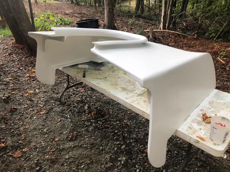 Slide: The Image of White fiberglass part for 1985 Cape Dory 270 boat on outdoor table. - 34
