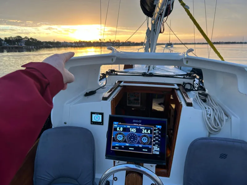 Slide: The Image of 1985 Cape Dory 270 sailboat cockpit with navigation display at sunset. - 37