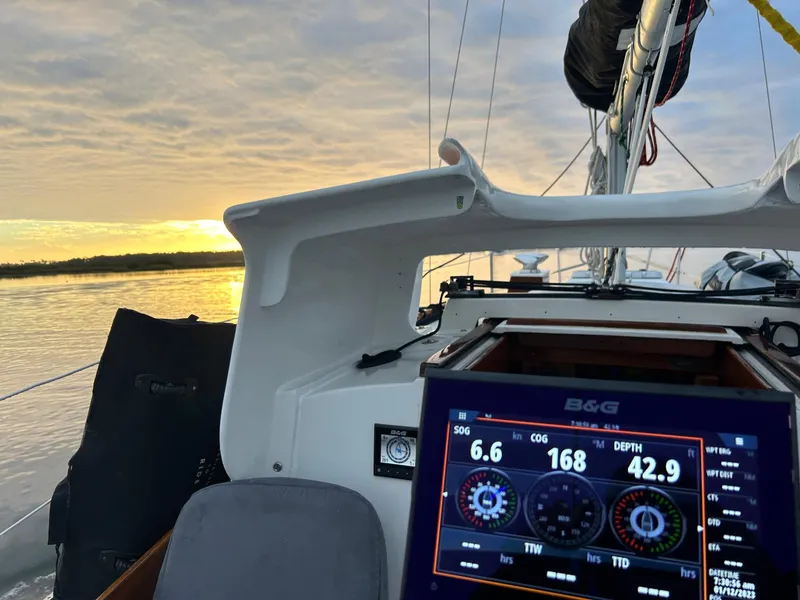 Slide: The Image of 1985 Cape Dory 270 sailboat cockpit with navigation display at sunset. - 42