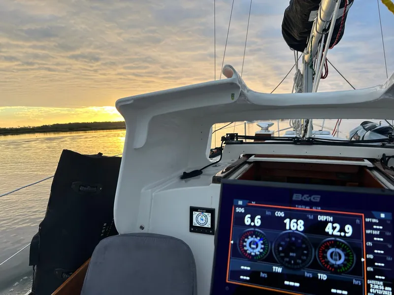 Slide: The Image of Cockpit view of 1985 Cape Dory 270 sailboat with navigation display at sunset. - 43