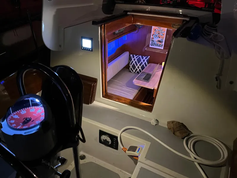 Slide: The Image of Interior view of 1985 Cape Dory 270 sailboat with cozy cabin and navigation equipment. - 46