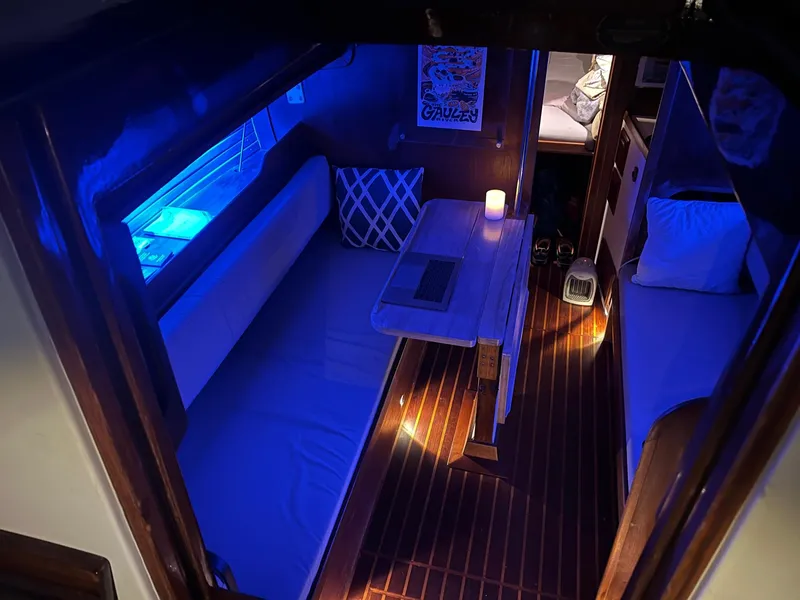 Slide: The Image of Interior of 1985 Cape Dory 270 sailboat with cozy seating and ambient lighting. - 47