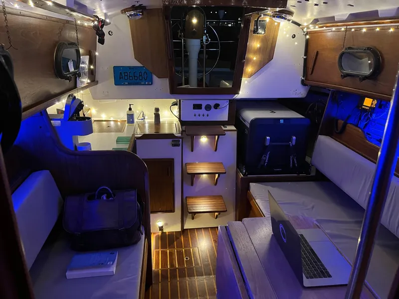 Slide: The Image of Interior of a 1985 Cape Dory 270 sailboat with cozy lighting and modern amenities. - 48