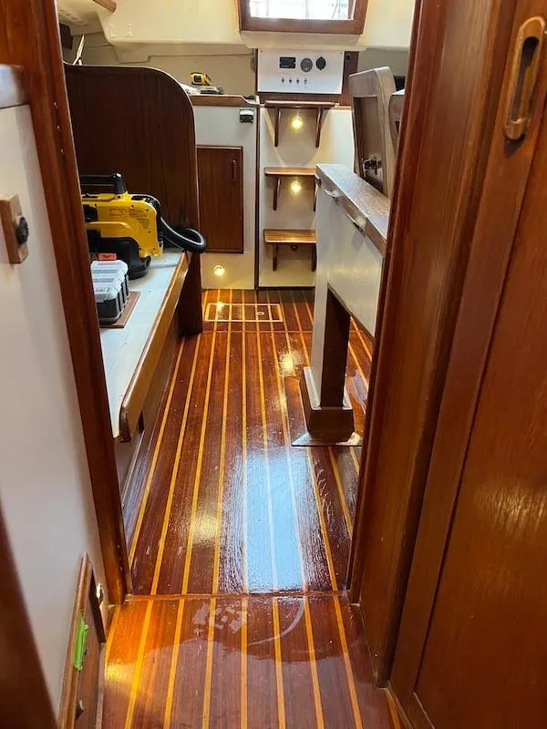 Slide: The Image of Interior of 1985 Cape Dory 270 sailboat with polished wooden flooring. - 49