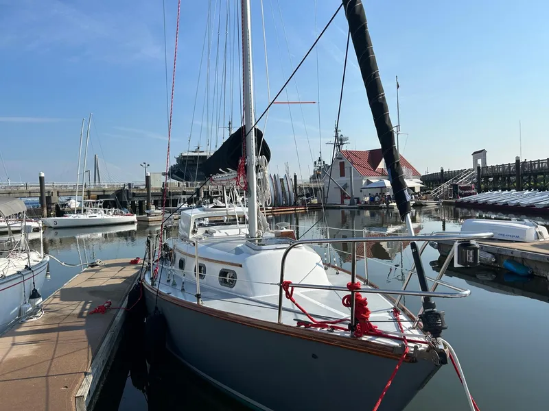 Slide: The Image of 1985 Cape Dory 270 sailboat docked in a marina on a sunny day. - 6