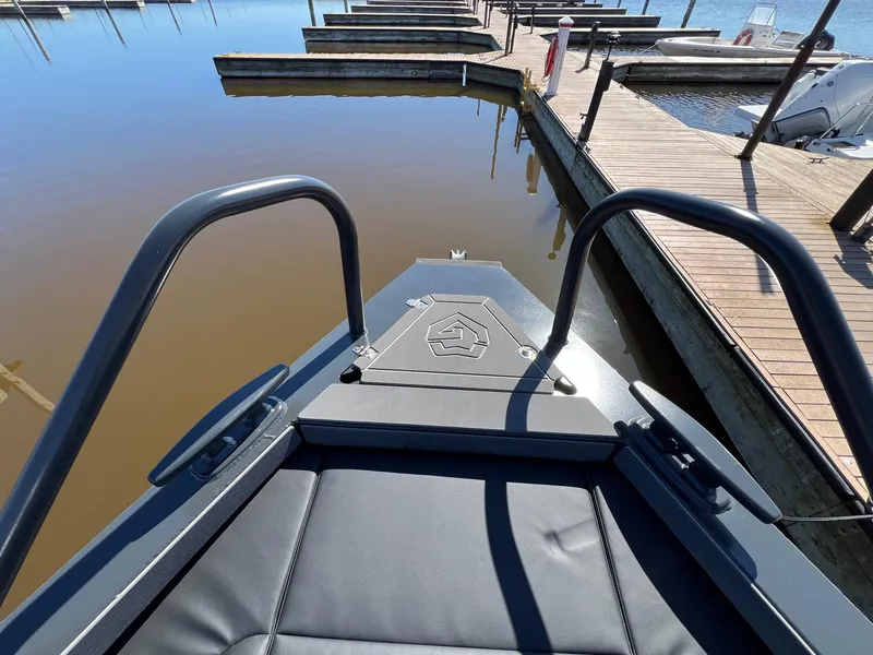 Slide: The Image of 2024 G-Force 10 boat docked at a marina, view from the bow. - 10