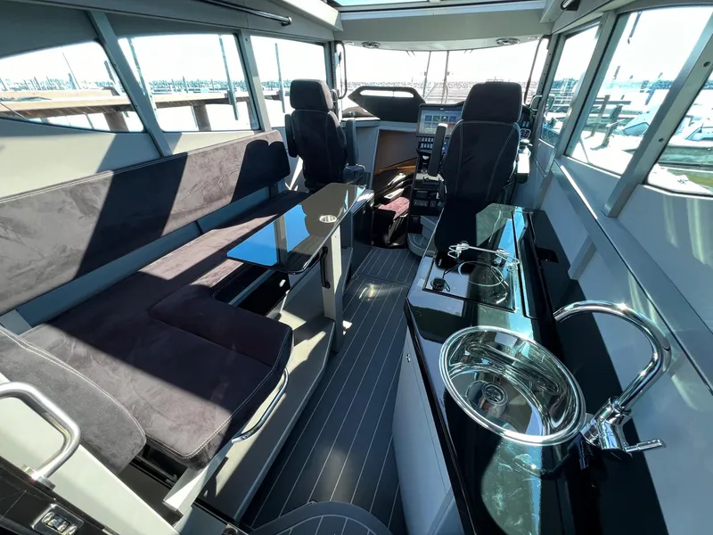 Slide: The Image of Interior of 2024 G-Force 10 boat with seating, table, and kitchenette. - 12