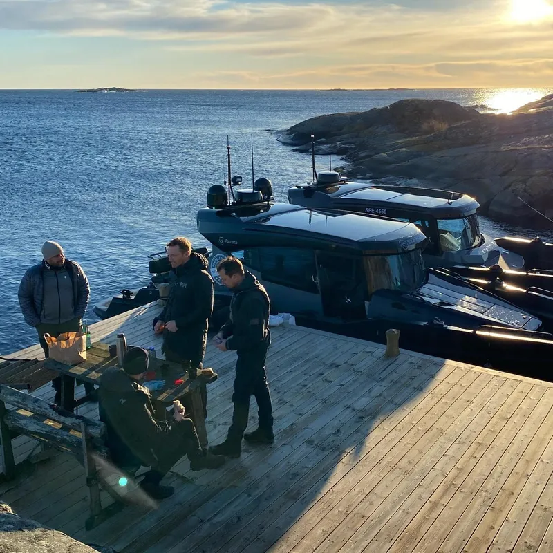 Slide: The Image of People relaxing on a dock beside 2024 G-Force 10 boats at sunset. - 37