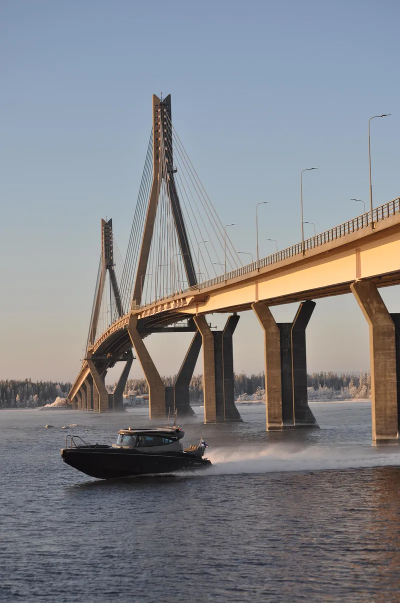 Slide: The Image of 2024 G-Force 10 speedboat cruising under a modern suspension bridge. - 41