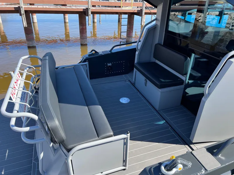 Slide: The Image of 2024 G-Force G-Force 10 boat interior with seating and dock view. - 5