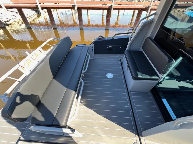 Slide: The Image of 2024 G-Force 10 boat interior with seating and dock view. - 6