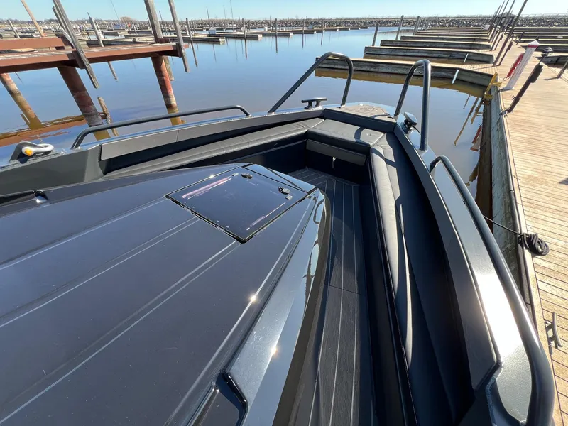 Slide: The Image of 2024 G-Force 10 boat docked at a marina, showcasing sleek design and spacious deck. - 9
