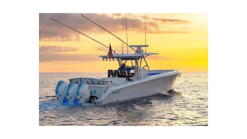 Slide: The Image of 2024 Bahama 37 Super Center Console boat cruising at sunset. - 6